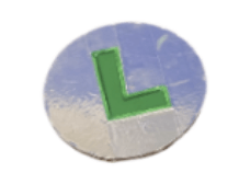 The classic green letter "L" representing Luigi, on a silver circular disk